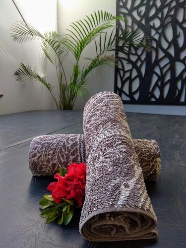 a bunch of flowers sitting on a table next to a pile at Kiwarrak Country Retreat in Old Bar