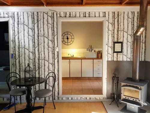 a kitchen with a table and a stove at Kiwarrak Country Retreat in Old Bar