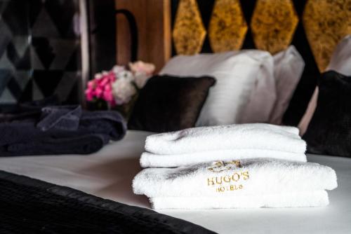 a pile of towels sitting on top of a bed at H Hotel & SPA - Adults Only in St Julian's