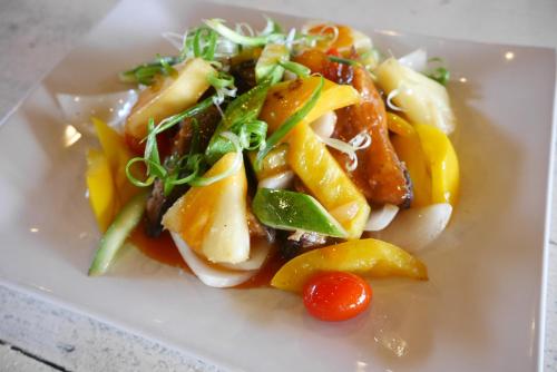 a white plate of food with fruit and vegetables at Zama Resort Koh Phangan in Haad Chao Phao