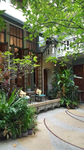 a building with a bunch of plants in front of it at Ariyasom Villa in Bangkok