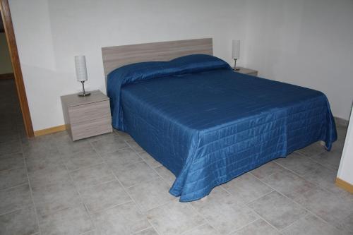 Ένα ή περισσότερα κρεβάτια σε δωμάτιο στο B&B Borgo Pileri