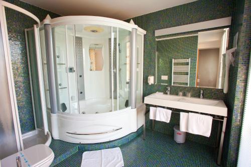 a bathroom with a shower and a sink at Hotel Creina in Kranj