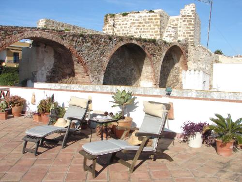 a group of chairs sitting on a patio at Darcilla Guest House in Tarifa