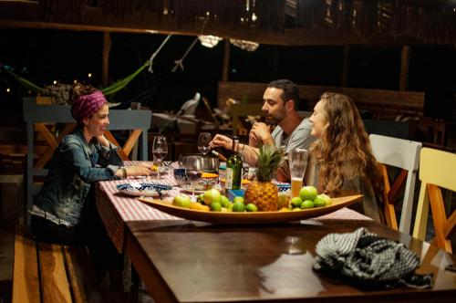 a group of people sitting around a table with a plate of fruit at Serrania del Viento in Barichara