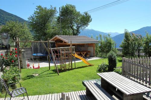 a yard with a playground and a house at Morigglhof in Malles Venosta