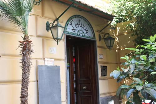 a door to a building with a sign on it at Barbarella Home in Naples