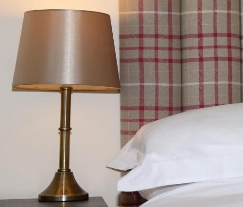 A bed or beds in a room at The Mulberry Inn 