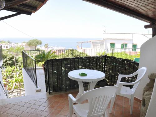a white table and chairs on a balcony at Hotel Villa Cimmentorosso in Ischia