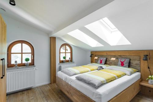 a bedroom with a large bed with a skylight at Alpenhaus Dachstein.Zauber in Abtenau