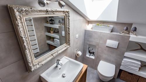 a bathroom with a sink and a mirror at Alpenhaus Dachstein.Zauber in Abtenau