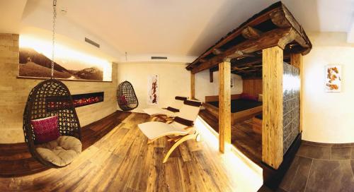 a room with a wooden floor and wooden walls at Hotel Birkenhof in Saalbach-Hinterglemm