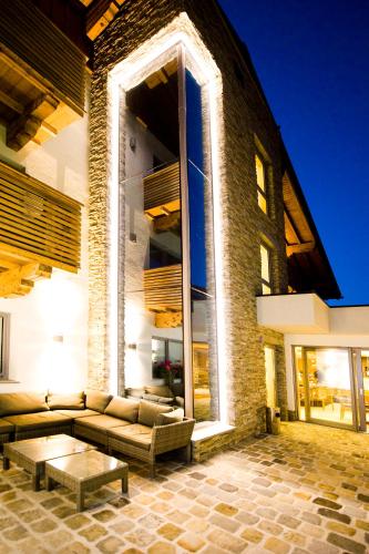 a large brick building with a couch and a table at Hotel Birkenhof in Saalbach Hinterglemm