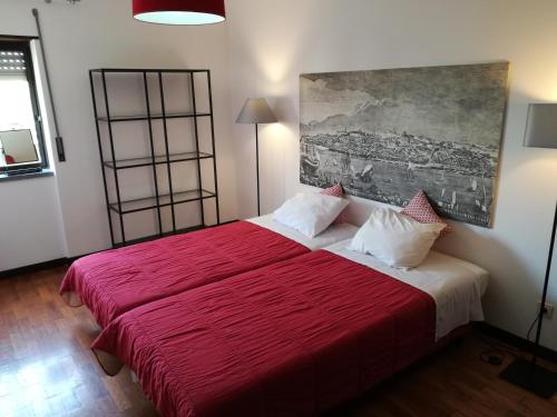 a bedroom with a red bed with a red blanket at Sintra/Colares Beach House with Mountain View in Sintra