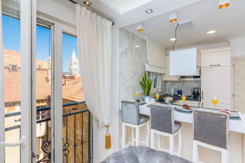 a kitchen with a view of a city at Francesca Baroque Apartment in Zadar