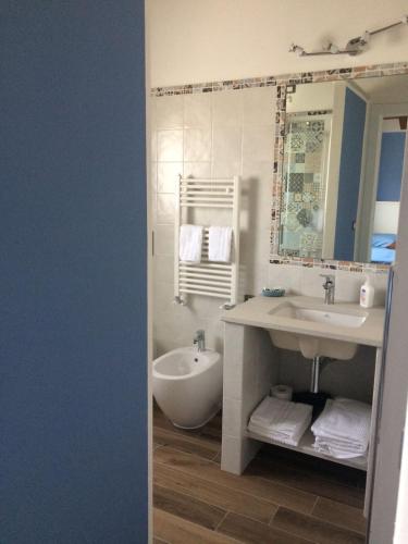 a bathroom with a sink and a tub and a mirror at B&b la valletta in Serravalle Scrivia