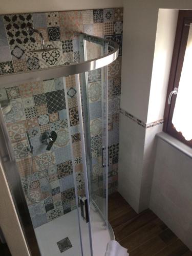 a shower with a glass door in a bathroom at B&b la valletta in Serravalle Scrivia
