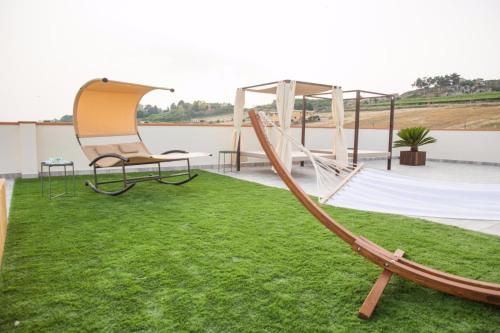 a playground with a slide and a swing at Attico in Canicattì