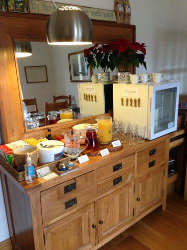 a wooden cabinet with a counter top with drinks on it at Langland Road B&B in The Mumbles