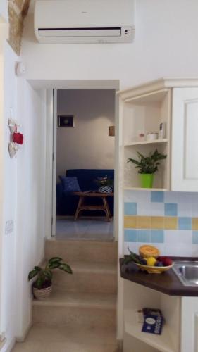 a stairway leading to a kitchen and a living room at Casa vacanze Elisir in Specchia