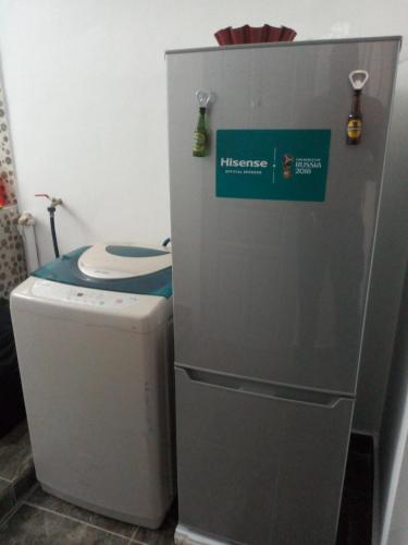 a bathroom with a refrigerator next to a toilet at Happy Welcome Bietry in Abidjan