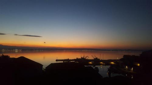 a sunset over a large body of water at Apartman Batalaza in Kali