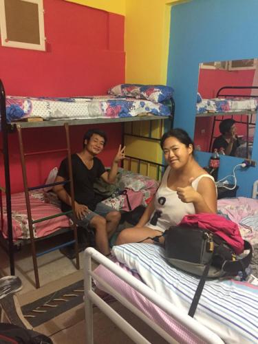 two people sitting in a room with bunk beds at david hostel in Aswan