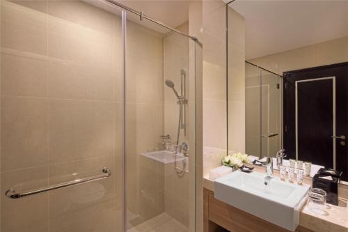a bathroom with a sink and a shower at Dorsett Hartamas Kuala Lumpur in Kuala Lumpur