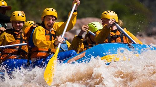 a group of people in a raft on a river at Complejo Atrapasueños in San Rafael