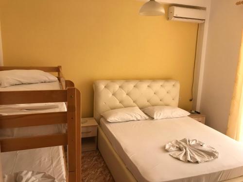 a small room with two bunk beds and a chair at Hotel President in Golem