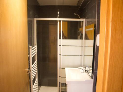 a bathroom with a sink and a shower with a mirror at Jimena in Burgos