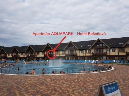 a large pool with people in it with a red arrow at Apartmán AQUAPARK - Hotel Bešeňová in Bešeňová