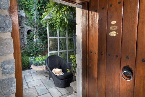 a doorway to a patio with a chair and a window at Sakali Mansion in Pinakátai