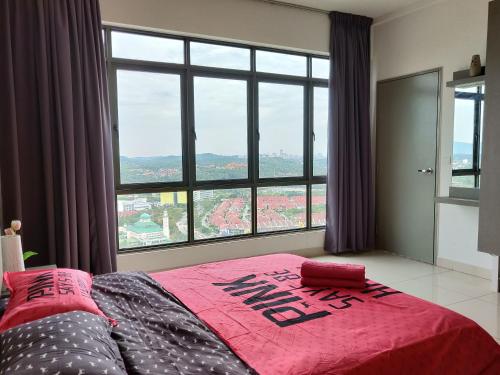 a bed in a bedroom with a large window at Comfort Zone Premium Guesthouse @ Evo Bangi in Bangi