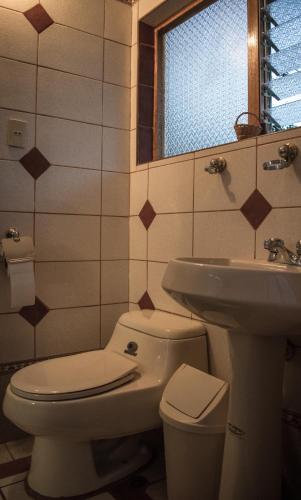 a bathroom with a toilet and a sink at Eco Lodge Los Perales-Urubamba in Urubamba