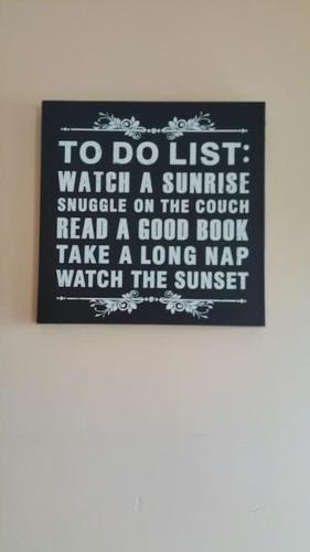 a sign that says to do just watch a sunriseundle on the couch read at Relaxing Break at Coshel View in Foyle Bridge