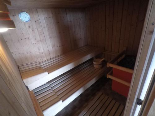 a small wooden sauna with a bench in it at Villa-Fuldablick in Morschen