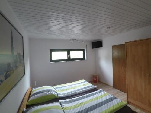 a bedroom with two beds and a window at Villa-Fuldablick in Morschen