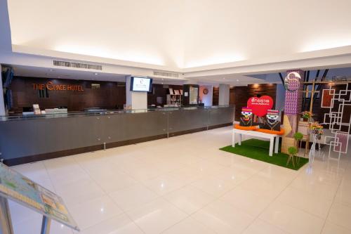 a shopping mall with a counter in the middle at The Space Hotel Chiang Rai in Chiang Rai
