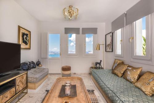 a living room with a couch and a tv at Summer Lovers Villa in Akrotiri