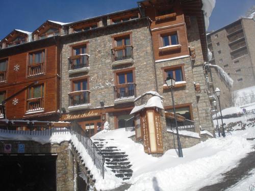 a building with snow in front of it at Hotel Soldeu Maistre in Soldeu