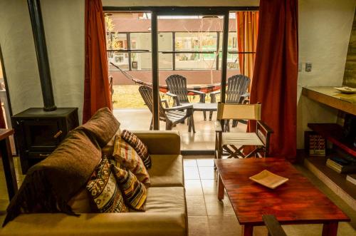 a living room with a couch and a wood stove at Complejo Atrapasueños in San Rafael