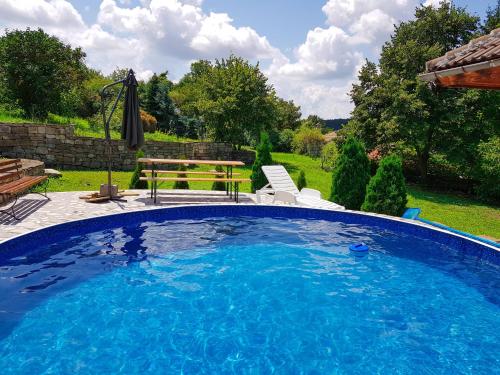 a swimming pool with a picnic table and a bench at Holiday Home Arbanasi in Arbanasi