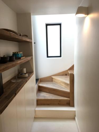 a staircase in a kitchen with a window at B&B PETIT PRINCE, GENT in Ghent