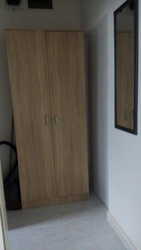 a room with two wooden cabinets in a room at Šušanj Ilino APARTMAN in Bar