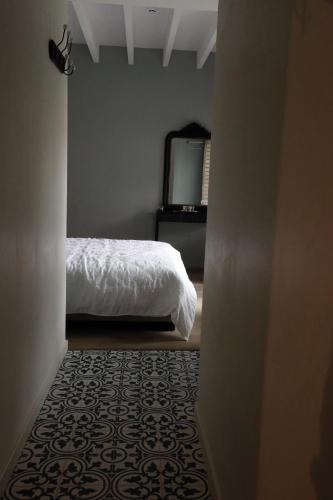 a bedroom with a bed and a dresser with a mirror at B&B PETIT PRINCE, GENT in Ghent