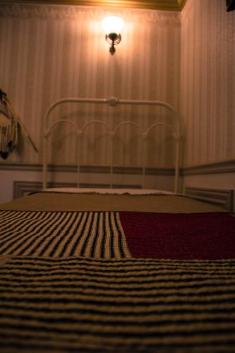 a bedroom with a bed with a light on the wall at Frisco Lodge in Frisco