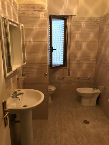 a bathroom with a sink and a toilet at Residence Lamezia Golfo in SantʼEufemia Lamezia