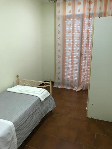 a bedroom with a bed and a shower curtain at Residence Lamezia Golfo in SantʼEufemia Lamezia