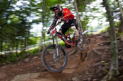 a man riding a dirt bike in the woods at Highland House in Snowshoe